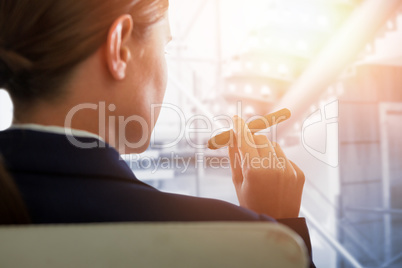 Composite image of businesswoman holding cigar