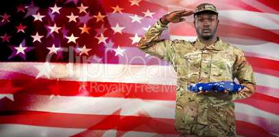 Composite image of portrait of soldier holding an american flag while