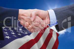 Composite image of businessman and woman doing handshake