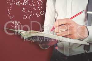 Composite image of mid section of man writing on diary