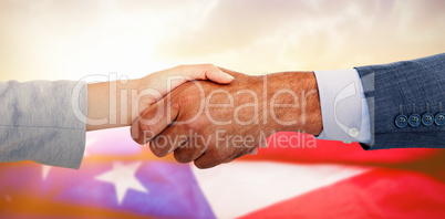 Composite image of business people shaking hands on white background