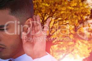 Composite image of close up of businessman trying to listen