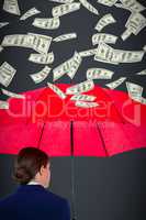 Composite image of rear view of businesswoman carrying red umbrella