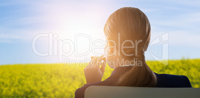 Composite image of rear view of businesswoman holding cigar