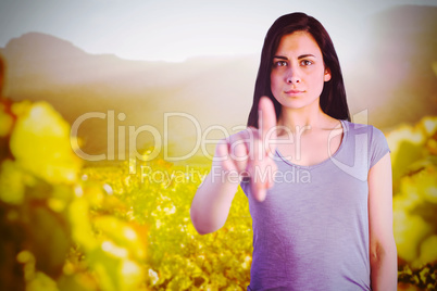 Composite image of portrait of young woman pointing