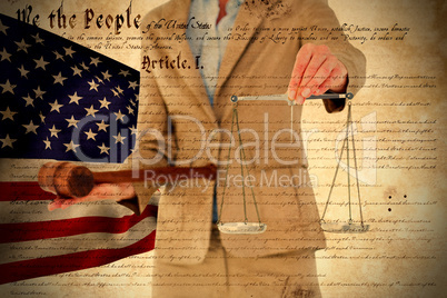 Composite image of young woman holding scales of justice and a gavel