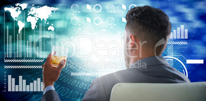 Composite image of rear view of businessman holding whisky glass