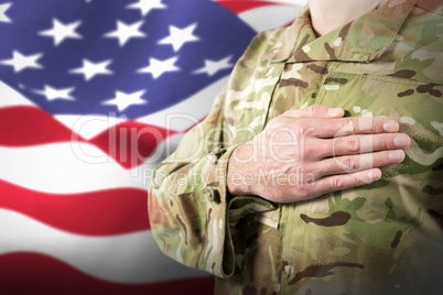 Composite image of mid section of soldier in uniform taking oath