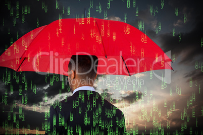 Composite image of rear view of businessman carrying red umbrella