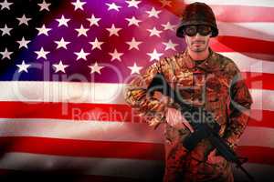 Composite image of portrait of soldier holding rifle
