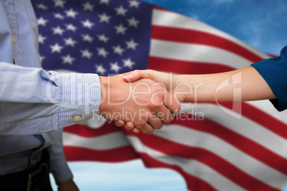 Composite image of male and female collegues shaking hands