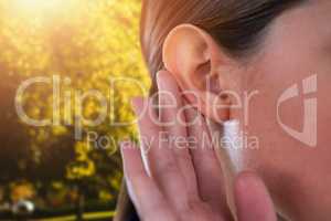 Composite image of close up of businesswoman trying to listen