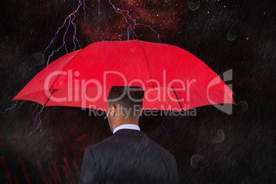 Composite image of rear view of businessman carrying red umbrella