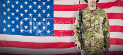 Composite image of portrait of soldier with rifle