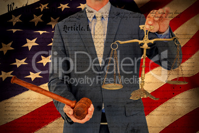 Composite image of male lawyer holding scale and gavel against white background