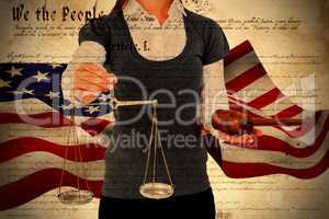 Composite image of woman holding a gavel and scales of justice