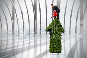 Composite image of businessman watering with red can