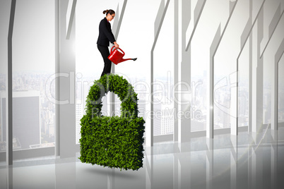 Composite image of businesswoman using red watering can