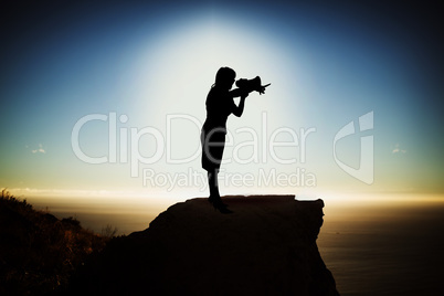 Composite image of silhouette businesswoman holding megaphone