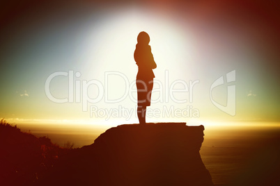 Composite image of thoughtful businesswoman standing isolated against white background