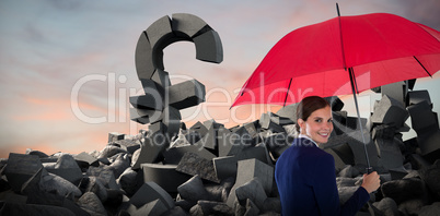 Composite image of portrait of smiling businesswoman holding red umbrella