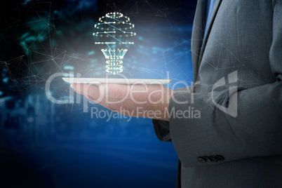 Composite image of businessman holding a digital tablet