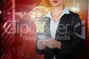 Composite image of businesswoman using mobile phone over white background