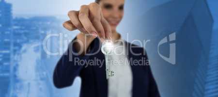 Composite image of smiling businesswoman showing new house key