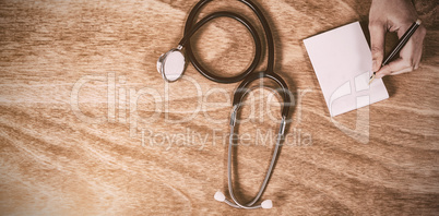 Doctor writing prescription on paper