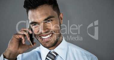 Composite image of smiling businessman talking on smart phone