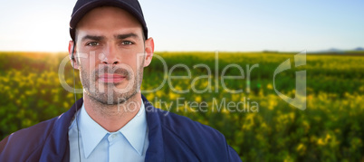 Composite image of portrait of handsome security officer