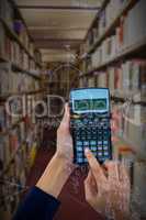 Composite image of hands of businesswoman using calculator