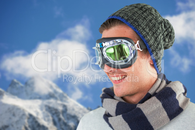Composite image of happy young man wearing aviator goggles against white background