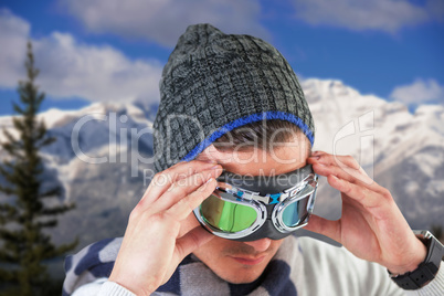Composite image of man wearing aviator goggles and hat