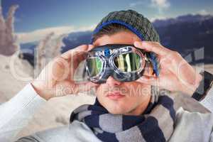 Composite image of unsmiling man wearing aviator goggles