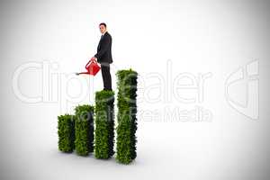 Composite image of businessman holding red watering can