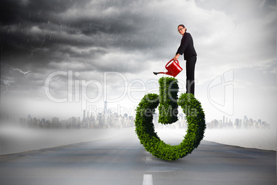 Composite image of businesswoman using red watering can