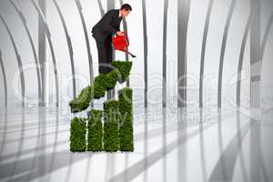 Composite image of businessman watering with red can