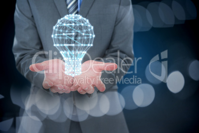 Composite image of midsection of businessman holding invisible object