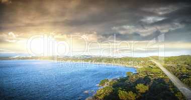 Scenic view of sea by grassy hill