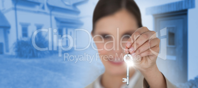 Composite image of close up of businesswoman showing new house key