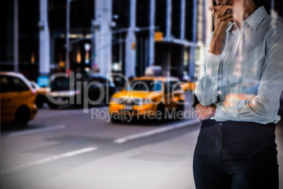 Composite image of thoughtful businesswoman standing with hand on face