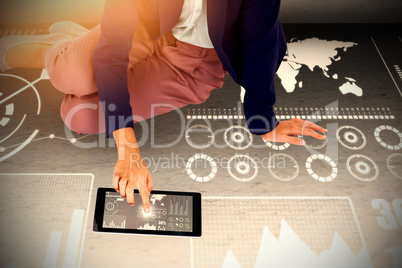 Composite image of low section of businesswoman using digital tablet on white background