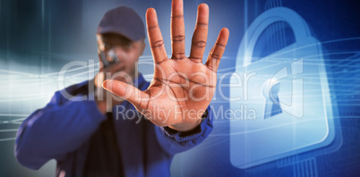 Composite image of confident security talking on walkie talkie and making stop gesture