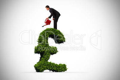 Composite image of businessman watering with red can