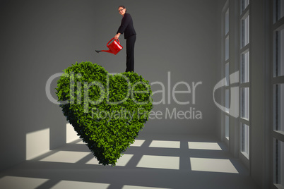 Composite image of businesswoman using red watering can