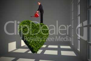 Composite image of businesswoman using red watering can