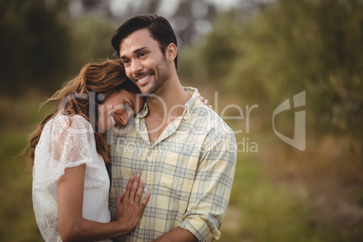Young couple embracing at olive farm