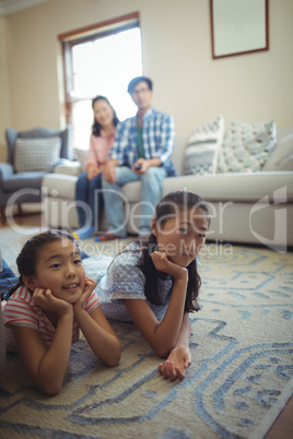 Family watching television together in living room