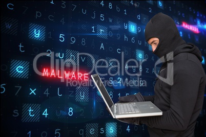 Hacker using a laptop with a digital background